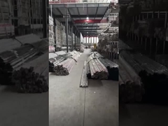 Stainless steel pipes neatly arranged on the shelves of the factory building